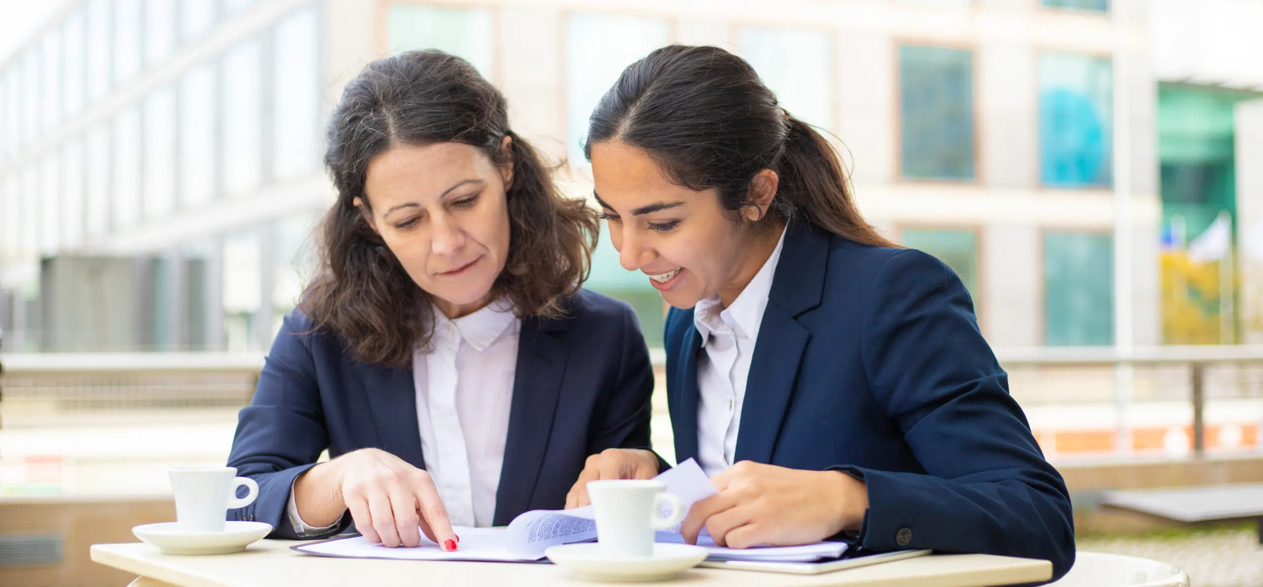 Businesswomen working with documents in outdoor cafe