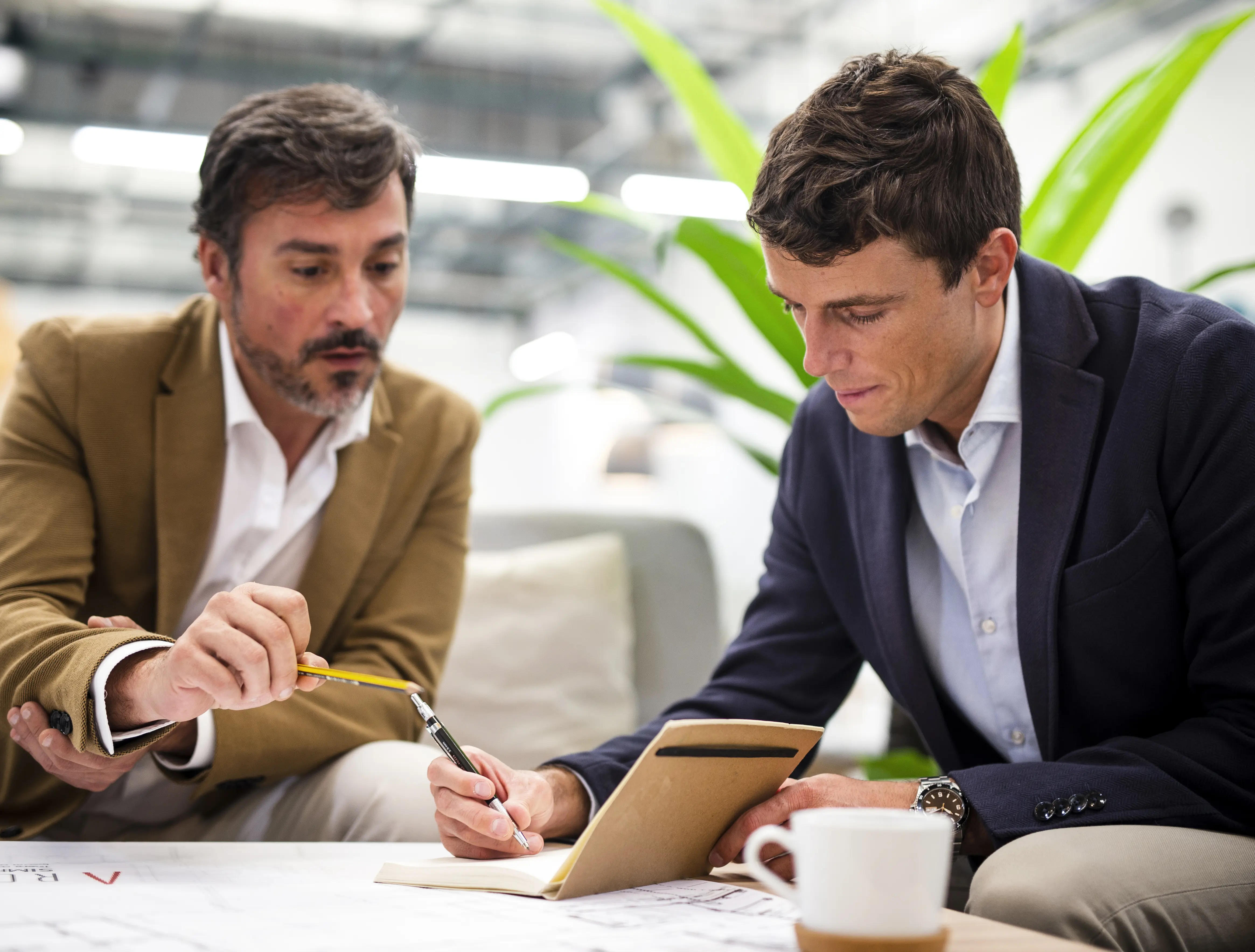 low-angle-male-coworkers-meeting-office