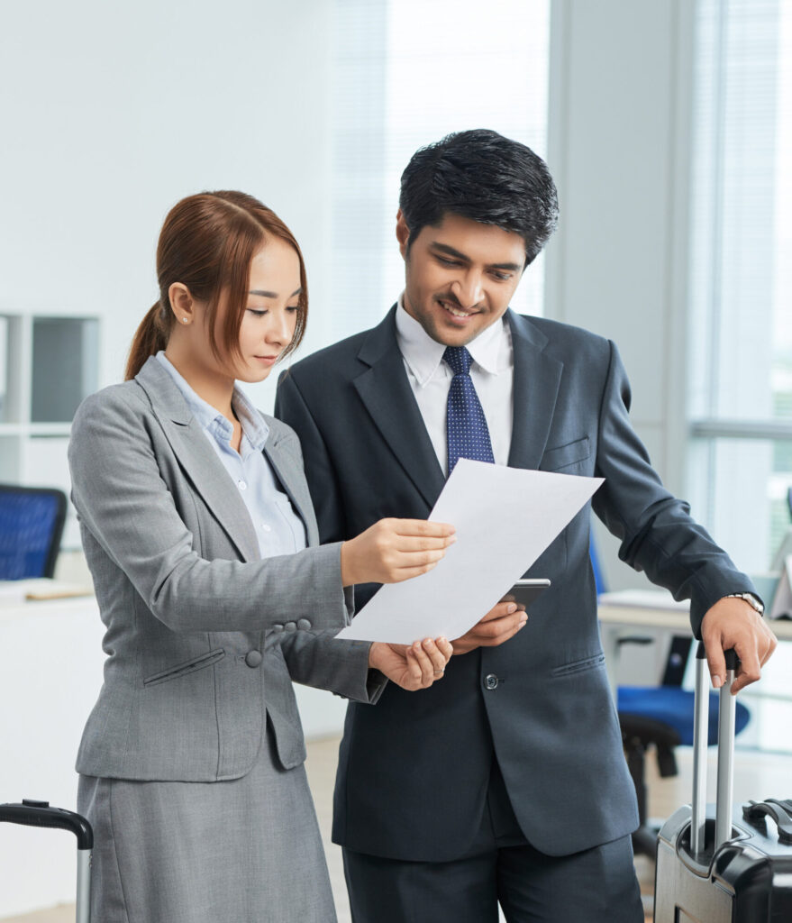 man-woman-business-suits-standing-office-with-suitcases-looking-together-document